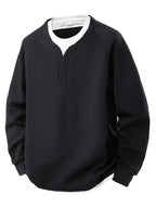 “ALTHORA™ Modern Layer Pullover — black pullover with built-in white layer and modern V-neck.”