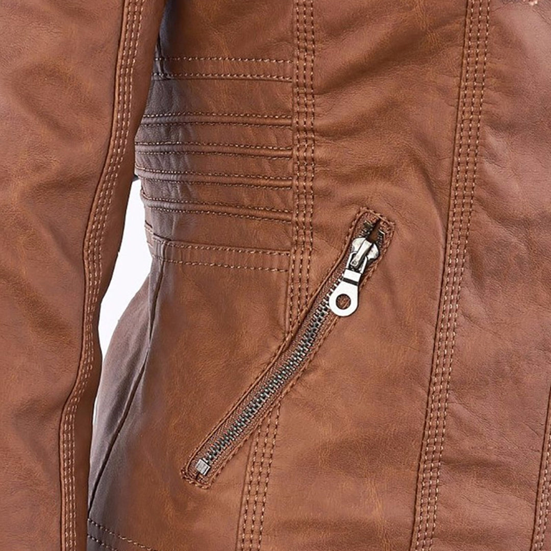 Studio shot of a women's fitted faux leather biker jacket in a warm cognac/light brown colour. The jacket has a front zipper closure, zippered chest and side pockets, detailed quilted shoulder and cuff panels, and an integrated fabric hood with drawstrings. The fit is clearly tailored and slim. Focus on the fitted silhouette and the texture of the faux leather.