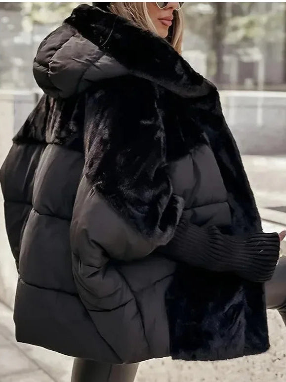 Model wearing Althora Urban Allure Coat in black — plush, oversized winter jacket with fur detailing.