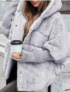 Model wearing Althora Urban Allure Coat in black — plush, oversized winter jacket with fur detailing.