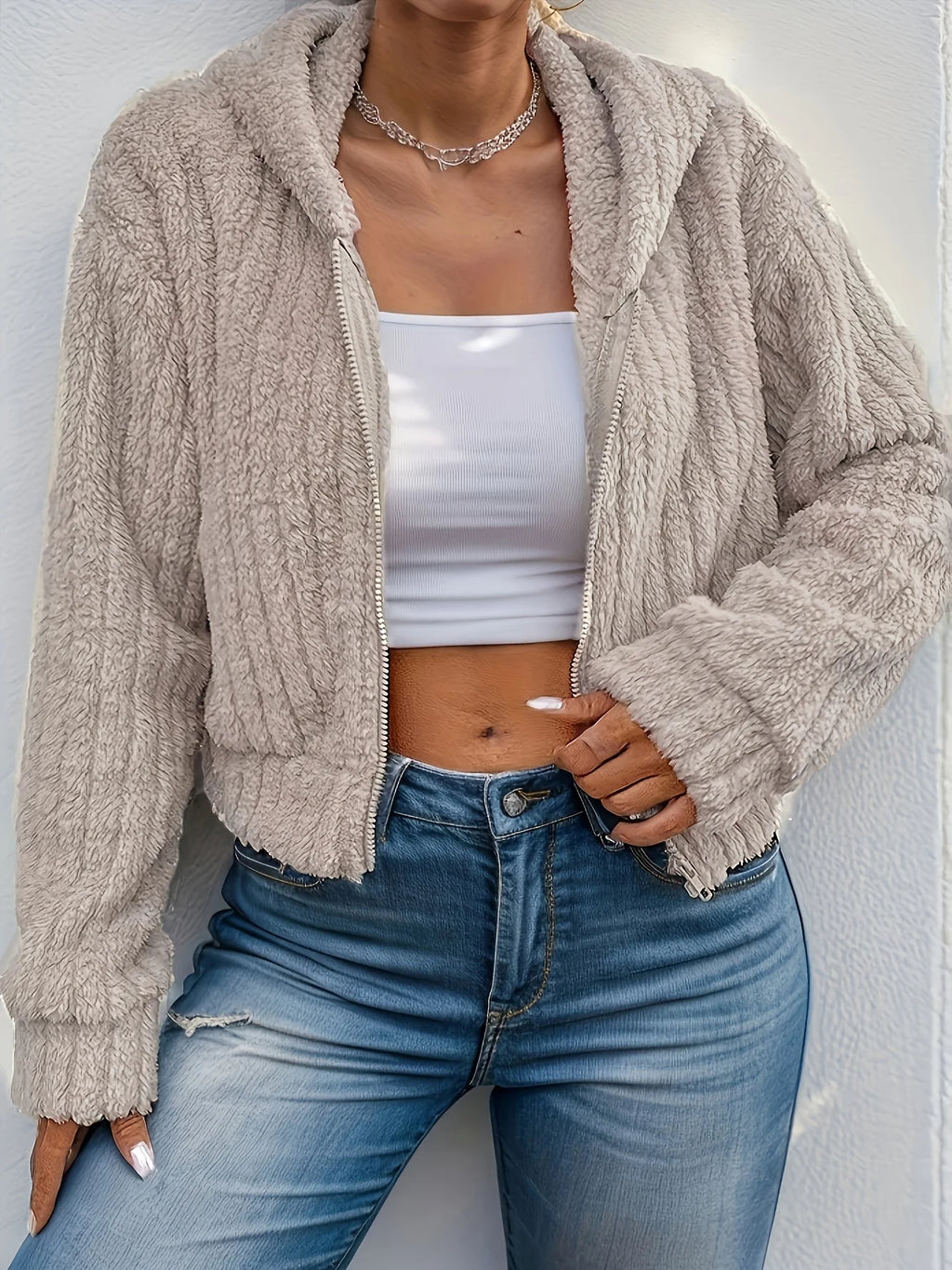 Model wearing Althora CloudSoft Zip Hoodie in beige — cropped fleece jacket with zip closure and hood.