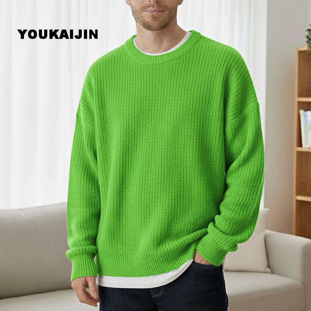 Close-up of a women's cropped, button-front sleeveless vest in a pale yellow/beige colour. The vest features a dense, chunky cable knit pattern and large brown round buttons. It is styled layered over a long-sleeve white shirt and tucked into light blue denim jeans. Focus on the rich cable texture and the cropped length.