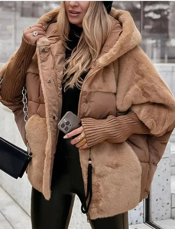 Model wearing Althora Urban Allure Coat in black — plush, oversized winter jacket with fur detailing.